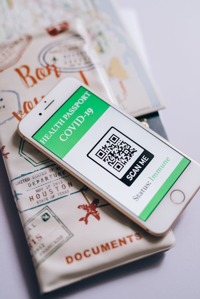 Smartphone displaying a COVID-19 health passport with QR code, indicating immunization status.